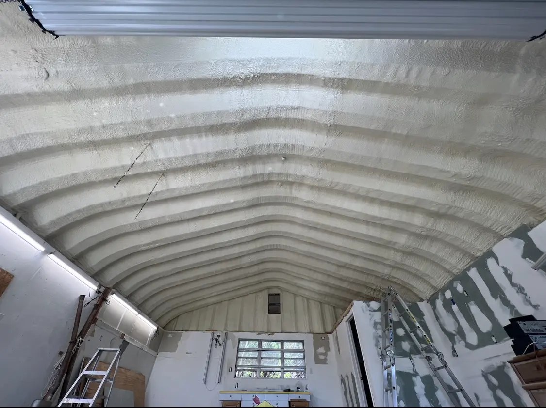 Spray polyurethane foam applied to the underside of a metal roof deck in Greencastle